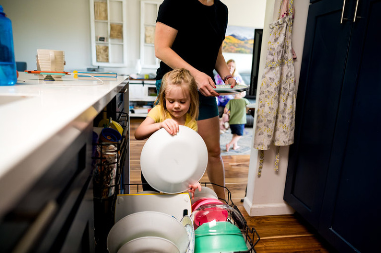 Little girl in the kitchen with mom helping unload the dishwasher by denver, colorado documentary photography company real life photo co