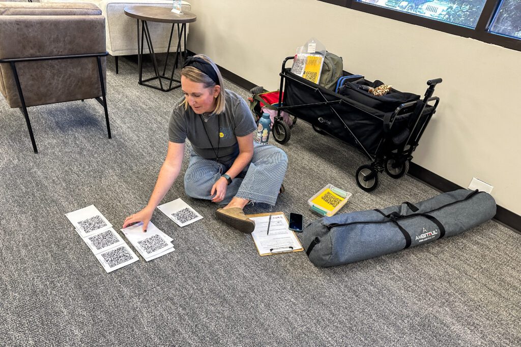 School photographer assistant preparing for school picture day at a school by grouping student identification cards.
